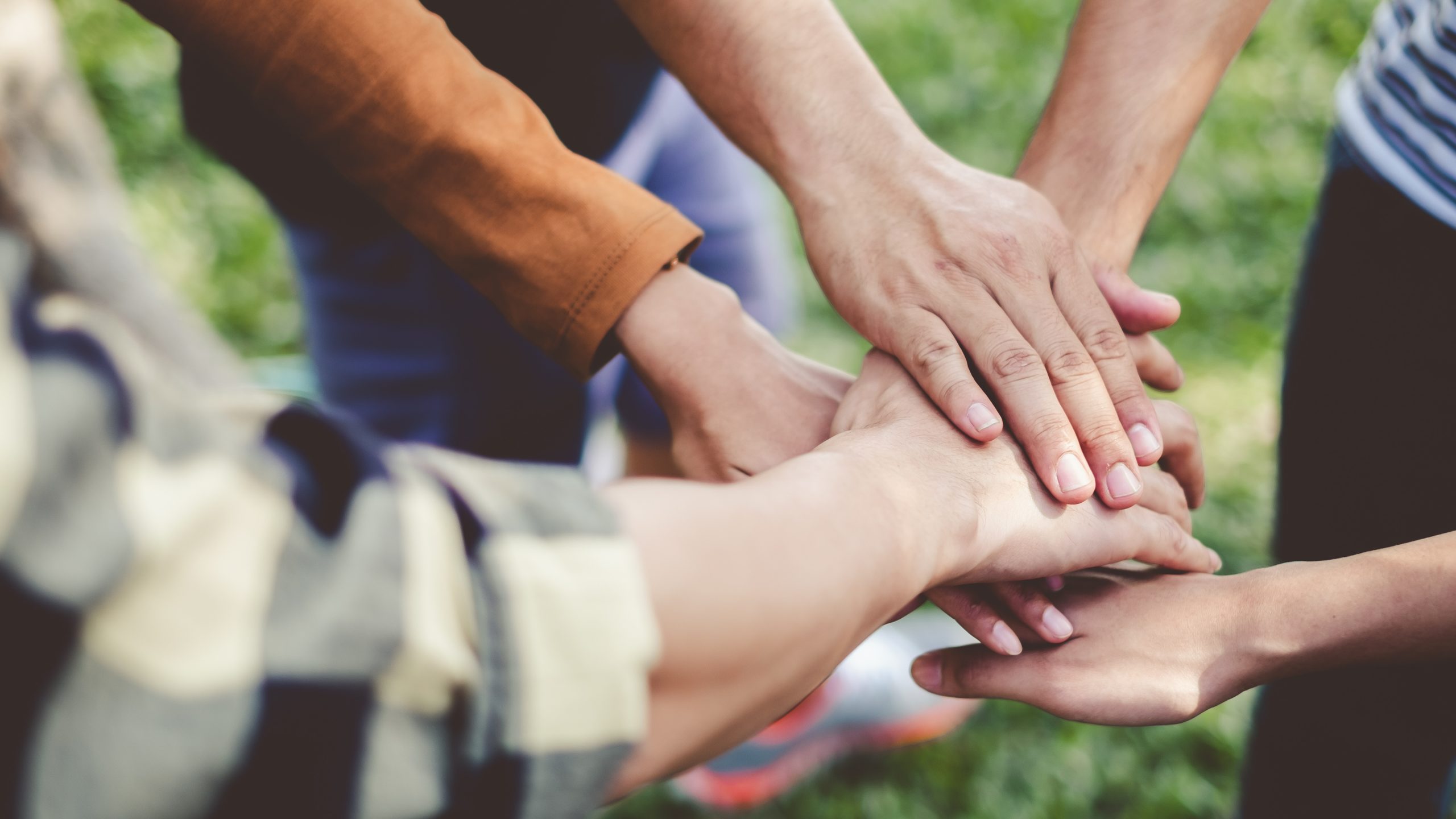 Stacking hands of young teen student, teamwork, togetherness and cooperation concept